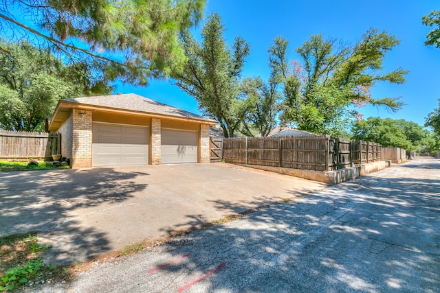 view of home's exterior with a garage and an outdoor structure