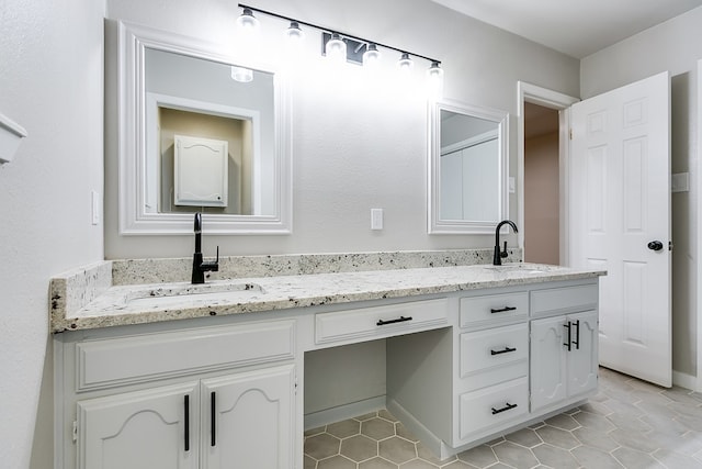 bathroom with tile patterned flooring and vanity