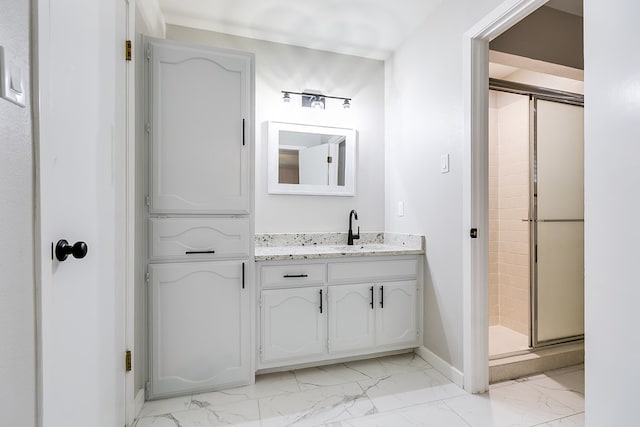 bathroom with an enclosed shower and vanity