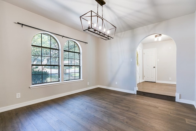 spare room with dark hardwood / wood-style flooring