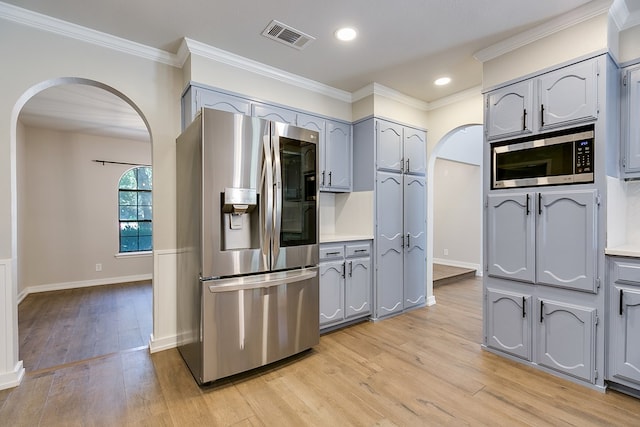 kitchen featuring gray cabinets, stainless steel appliances, and light hardwood / wood-style floors