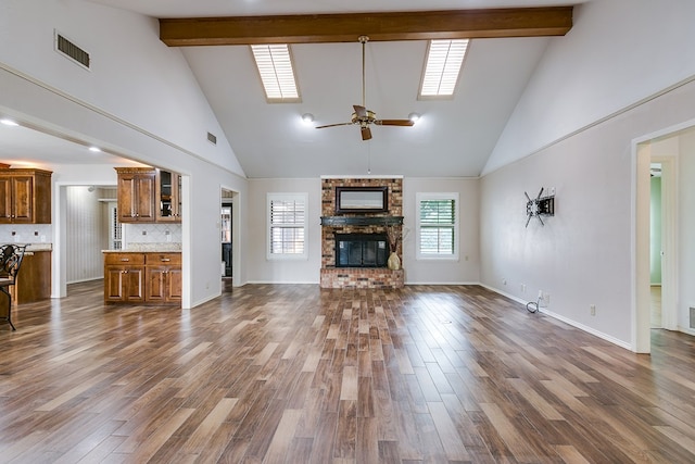 living room with dark hardwood / wood-style flooring, a brick fireplace, and beam ceiling