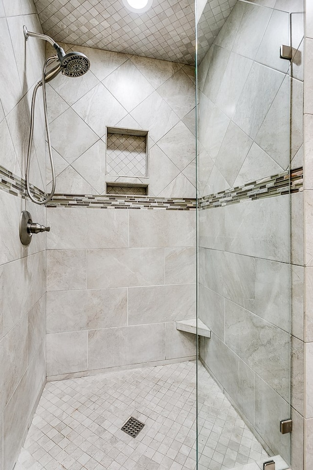 bathroom with a shower with door