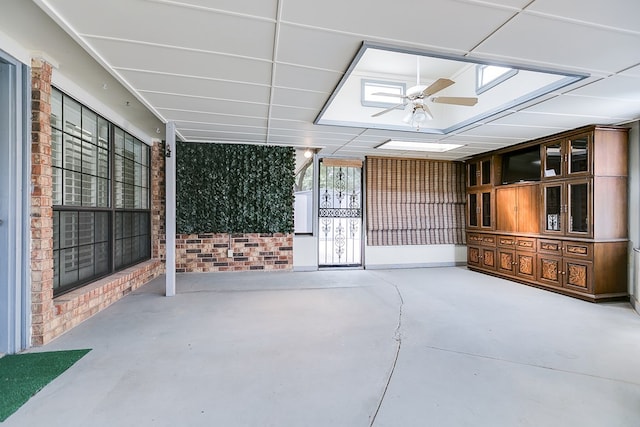 sunroom / solarium featuring ceiling fan