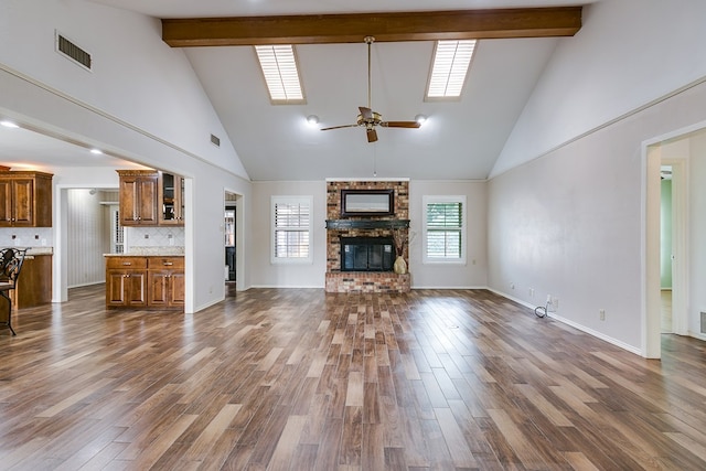 unfurnished living room featuring a fireplace, dark hardwood / wood-style flooring, and beam ceiling