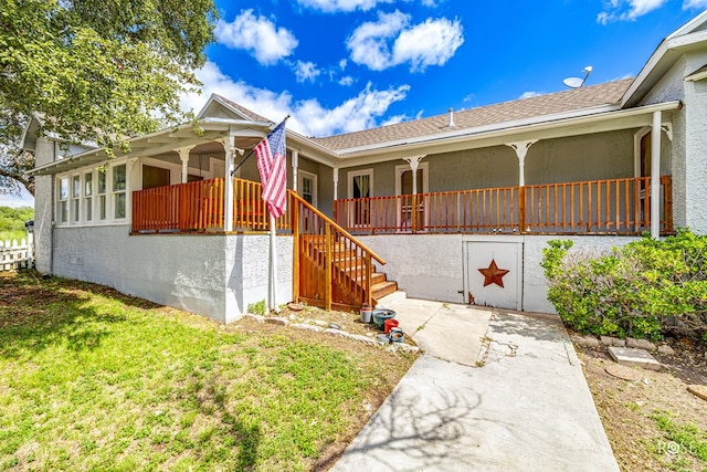 exterior space featuring a porch and a front yard