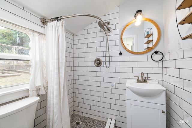 bathroom featuring vanity, lofted ceiling, toilet, and walk in shower