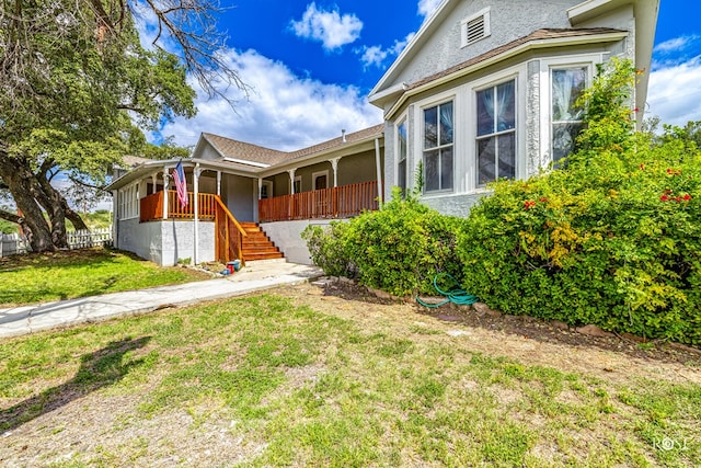 view of front of home with a front yard and a porch