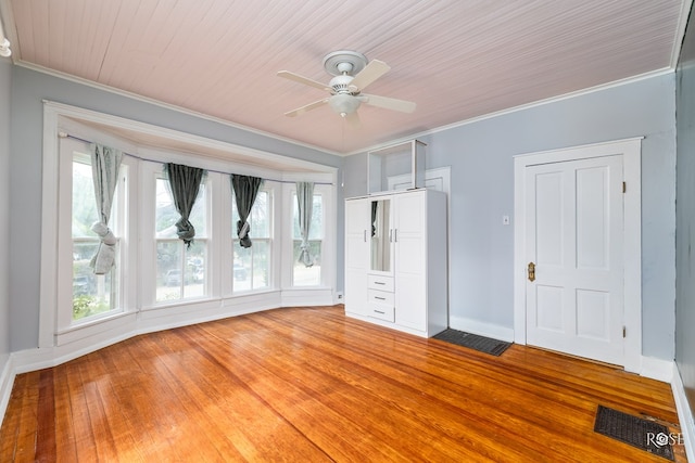 spare room with ornamental molding, wood-type flooring, and ceiling fan