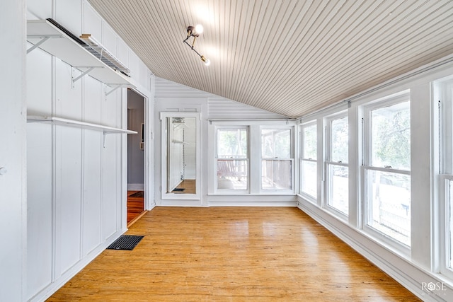 unfurnished sunroom with vaulted ceiling and a healthy amount of sunlight