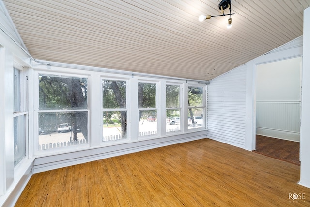 unfurnished sunroom featuring vaulted ceiling, a wealth of natural light, and wooden ceiling