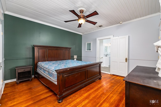 bedroom with dark wood-type flooring, ceiling fan, ornamental molding, and ensuite bathroom