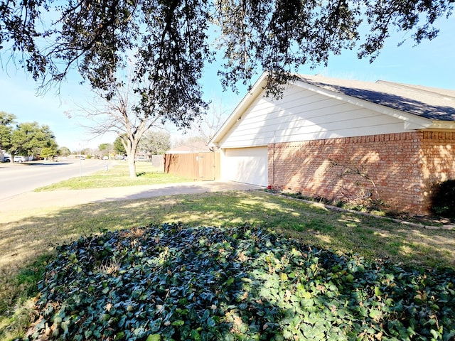 view of home's exterior featuring a garage and a yard