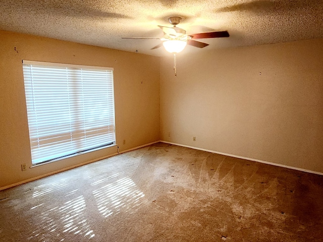 spare room featuring a textured ceiling, plenty of natural light, and ceiling fan