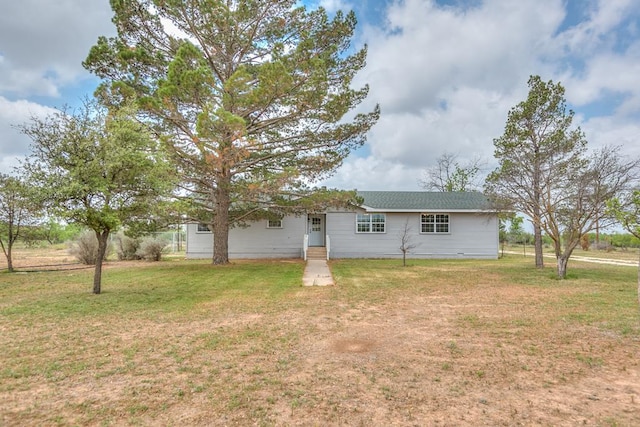 rear view of property with a yard