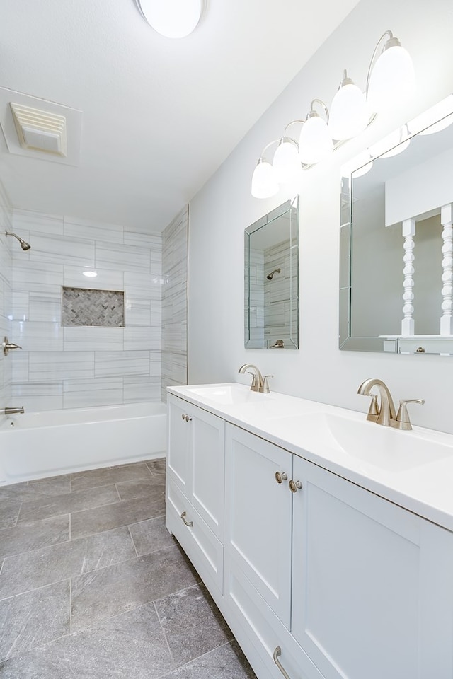 bathroom featuring vanity and tiled shower / bath combo