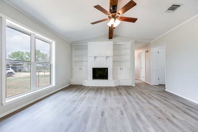 unfurnished living room featuring a fireplace, lofted ceiling with beams, light hardwood / wood-style floors, and ceiling fan