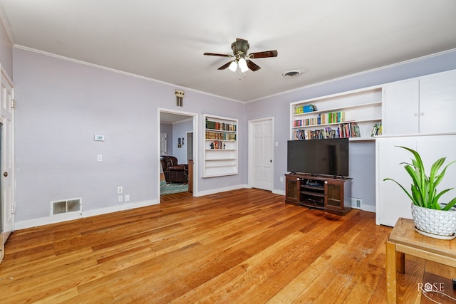 unfurnished living room featuring crown molding, built in shelves, light hardwood / wood-style flooring, and ceiling fan