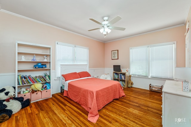 bedroom featuring multiple windows, dark wood-type flooring, ornamental molding, and ceiling fan