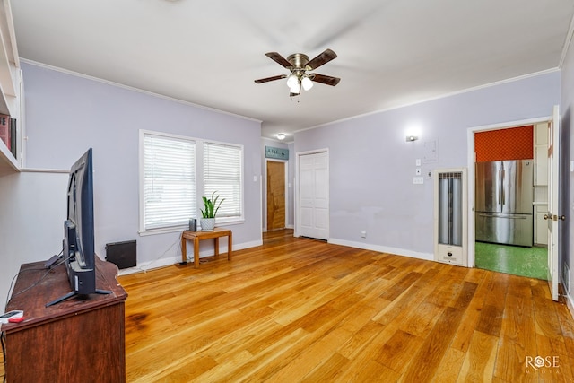 living room with hardwood / wood-style flooring, ornamental molding, and ceiling fan