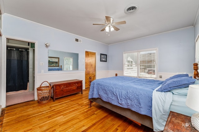 bedroom featuring ceiling fan, ornamental molding, and light hardwood / wood-style flooring