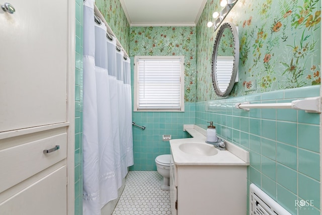 bathroom with tile walls, ornamental molding, vanity, toilet, and tile patterned floors