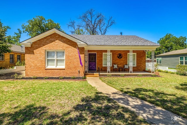 ranch-style home with a porch and a front lawn