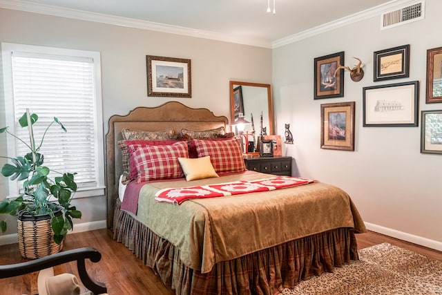 2611 Live Oak St, San Angelo, TX 76901 - bedroom with wood finished floors, multiple windows, and ornamental molding