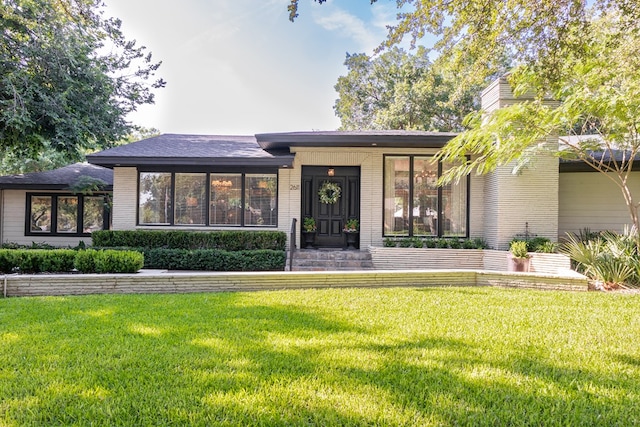2611 Live Oak St, San Angelo, TX 76901 - view of front of home featuring a front lawn and brick siding