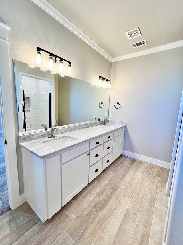 bathroom with crown molding, vanity, and walk in shower