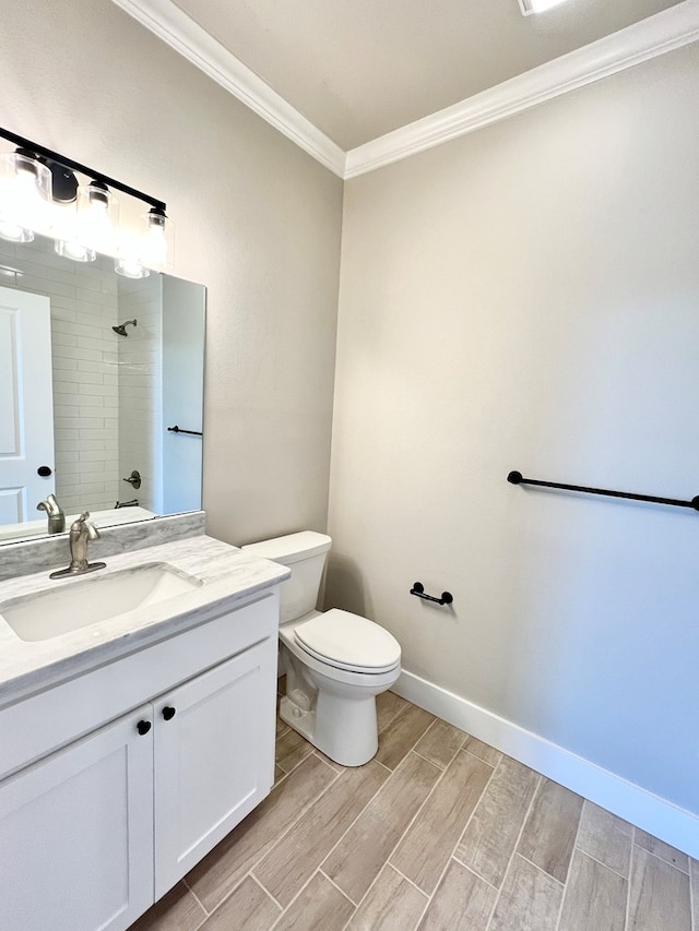 bathroom with vanity, ornamental molding, and toilet