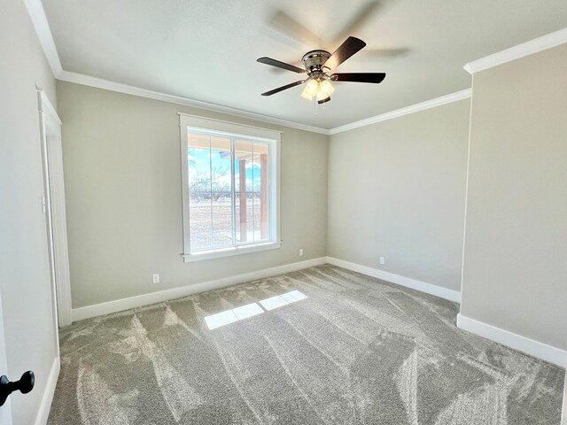 carpeted empty room with ornamental molding and ceiling fan