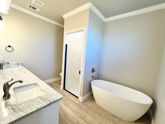 full bathroom with ornamental molding, vanity, toilet, and independent shower and bath