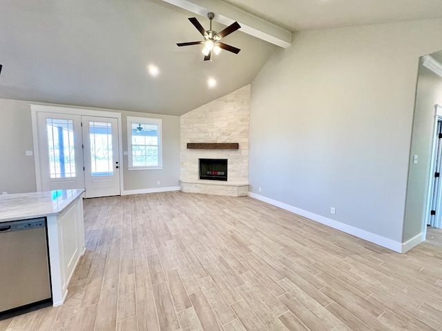 unfurnished living room featuring ceiling fan, high vaulted ceiling, a fireplace, light hardwood / wood-style floors, and beamed ceiling