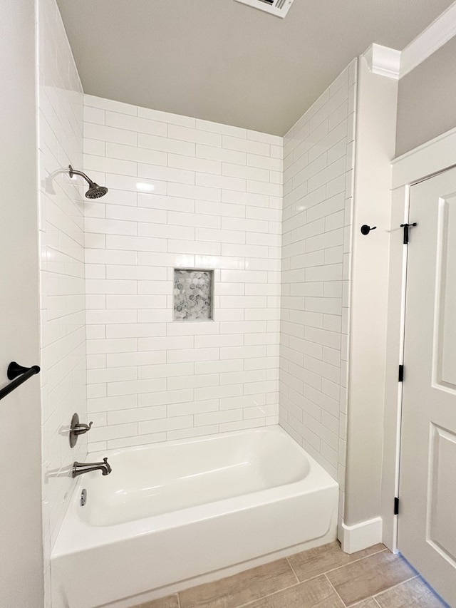 bathroom with ornamental molding and  shower combination