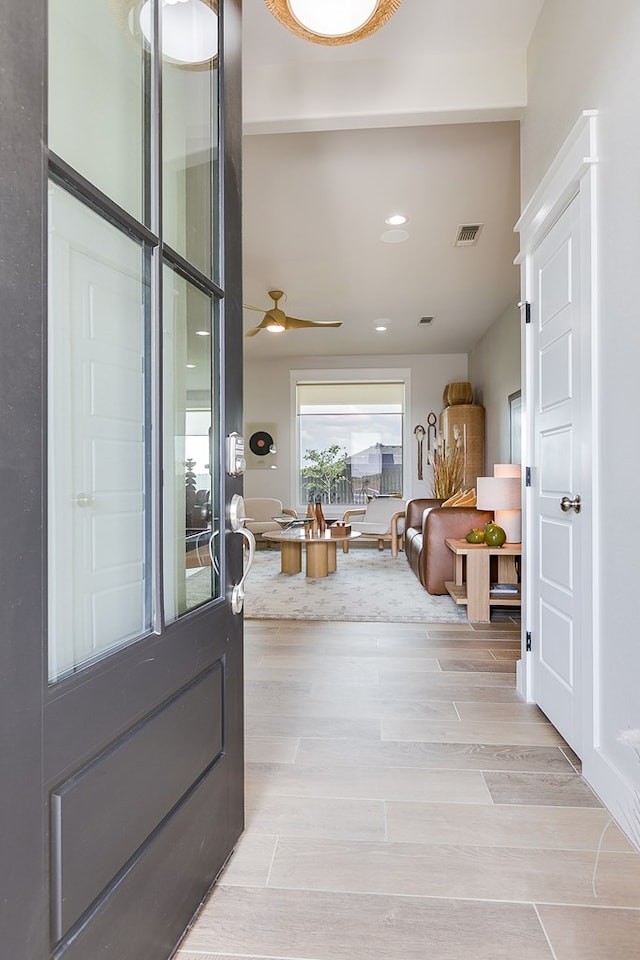entryway with recessed lighting, ceiling fan, light wood finished floors, and visible vents