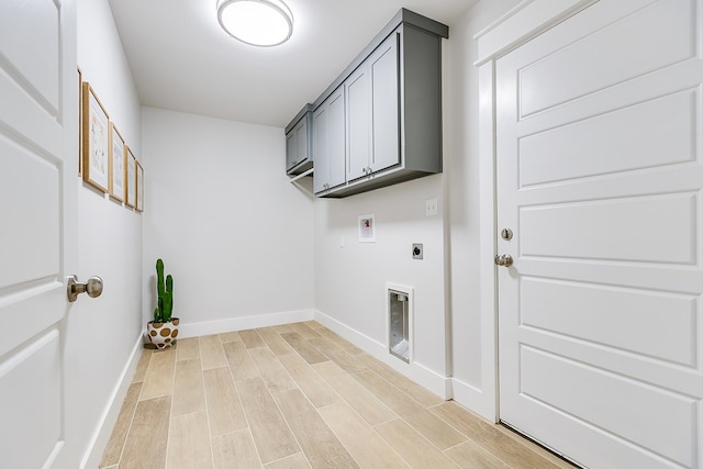 laundry room with cabinet space, washer hookup, light wood-style flooring, baseboards, and electric dryer hookup