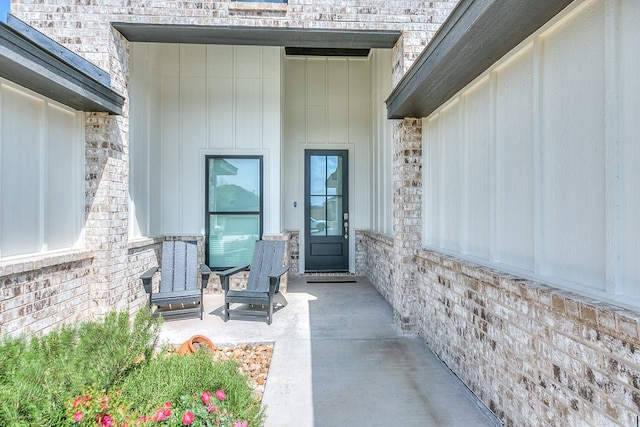 entrance to property featuring brick siding
