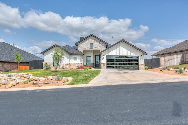 view of front of home with fence, a front yard, board and batten siding, an attached garage, and driveway