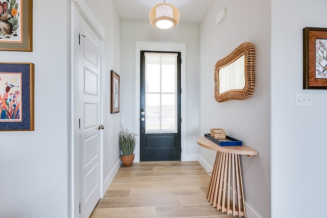 entryway featuring baseboards and light wood-style flooring