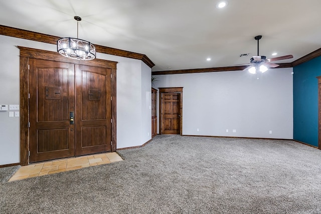 carpeted foyer entrance with crown molding and ceiling fan