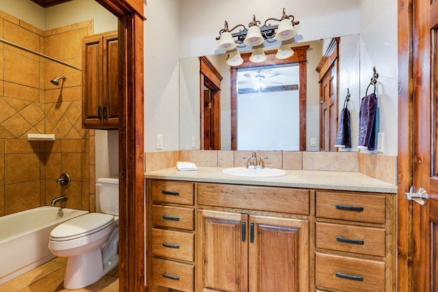 full bathroom with tiled shower / bath, vanity, tile patterned floors, and toilet