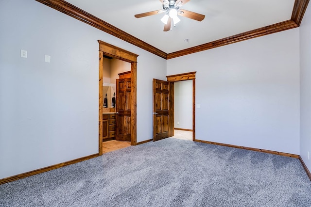 unfurnished bedroom featuring ornamental molding, light carpet, ceiling fan, and ensuite bath