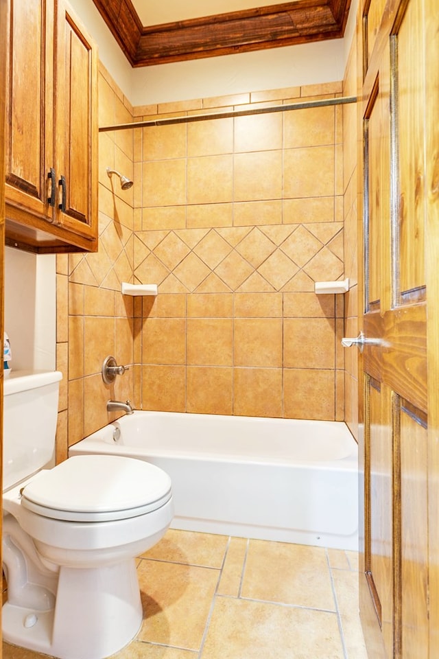 bathroom with tiled shower / bath combo, ornamental molding, tile patterned flooring, and toilet