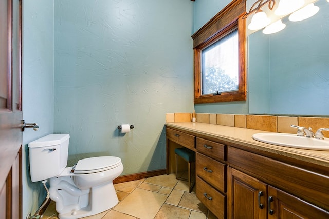 bathroom featuring vanity, tile patterned flooring, and toilet