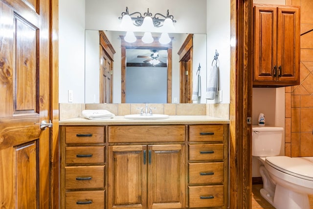 bathroom featuring vanity, ceiling fan, and toilet