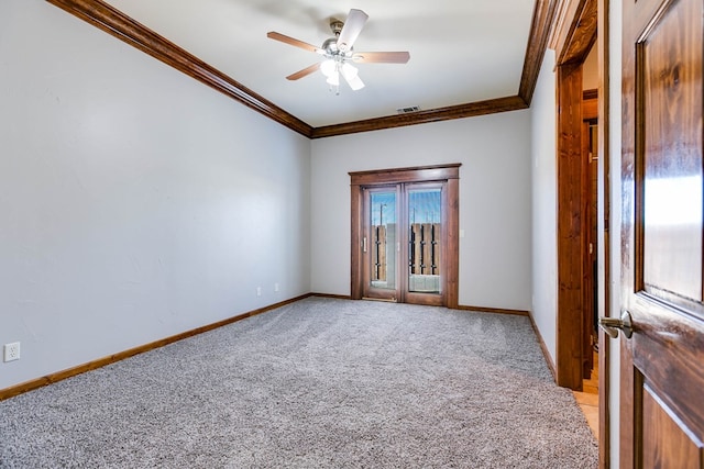 empty room with light colored carpet, ornamental molding, and ceiling fan