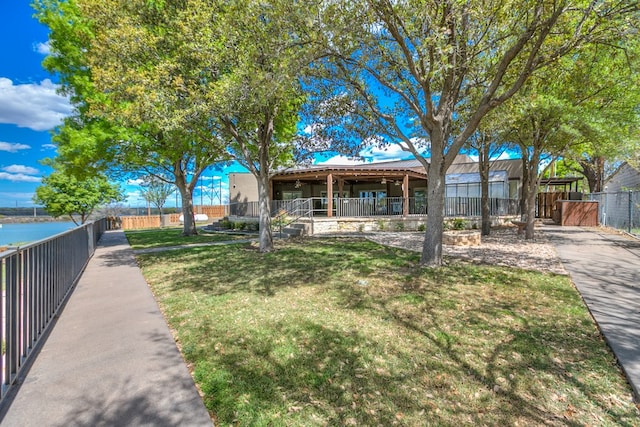 view of front facade with a front lawn and a water view