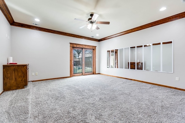 spare room featuring ceiling fan, ornamental molding, and carpet flooring