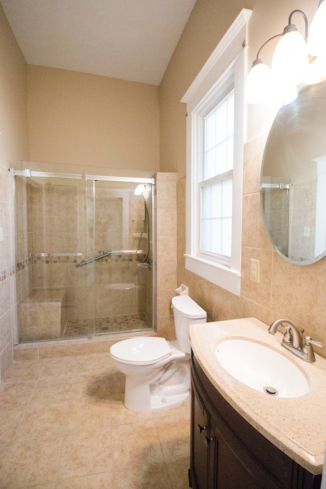 full bath featuring toilet, a stall shower, and vanity